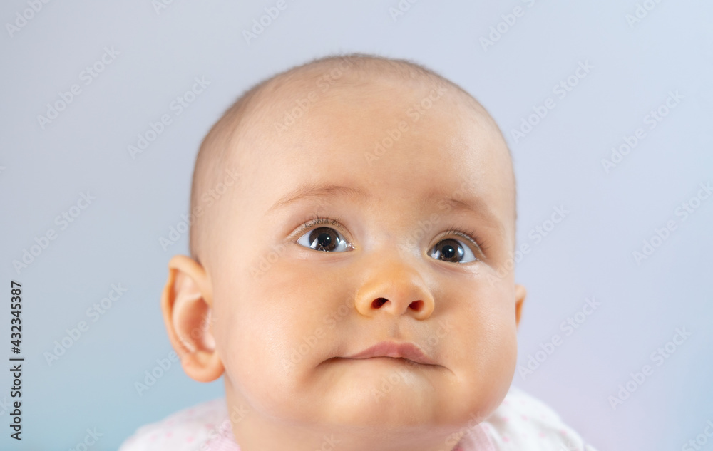 Portrait of a newborn baby 8-10 months old with pursed lips Portrait of a newborn baby 8-10 months old with pursed lips