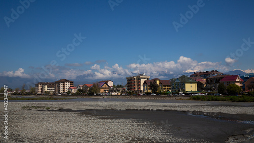 Roofs of houses against the background of mountains and the sky. town in a mountainous area