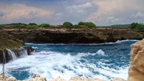 Ocean waves hitting the rock photo