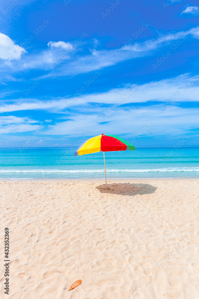 A colourful umbrella on white beach.