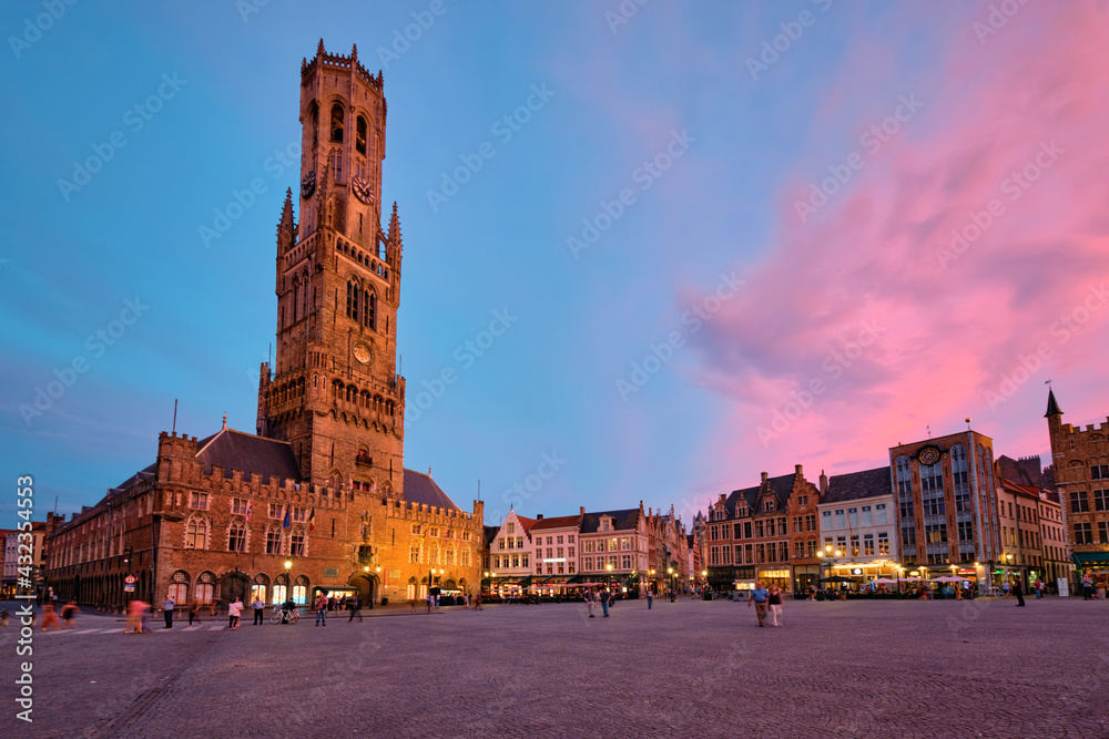 Belfry tower and Grote markt square in Bruges, Belgium on dusk in twilight
