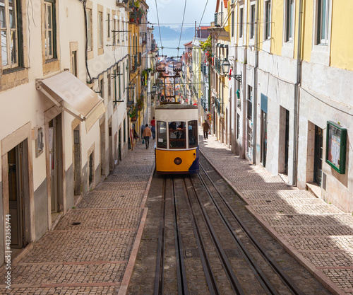 Lisbon. Old yellow traditional city tram on a sunny morning.