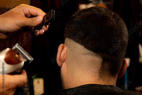 cut styles with scissors and machines in a vintage men's barbershop
