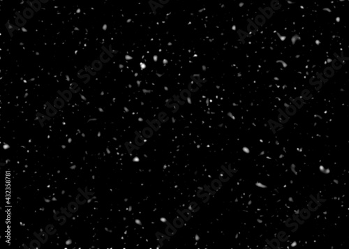 Snowfall on black background, an abstract background.