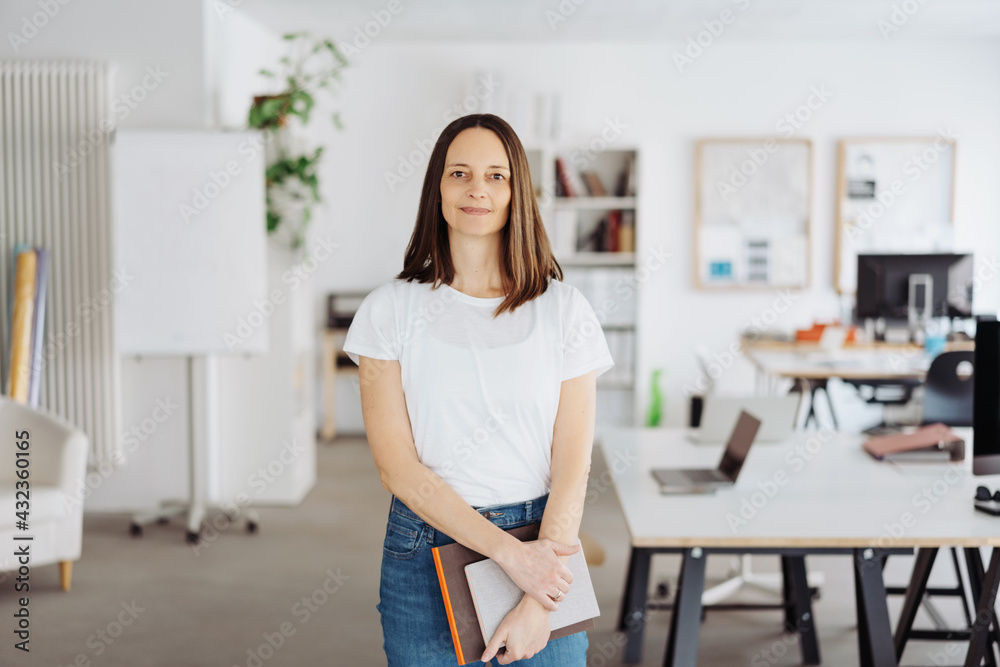 Relaxed modern casual businesswoman standing in the office