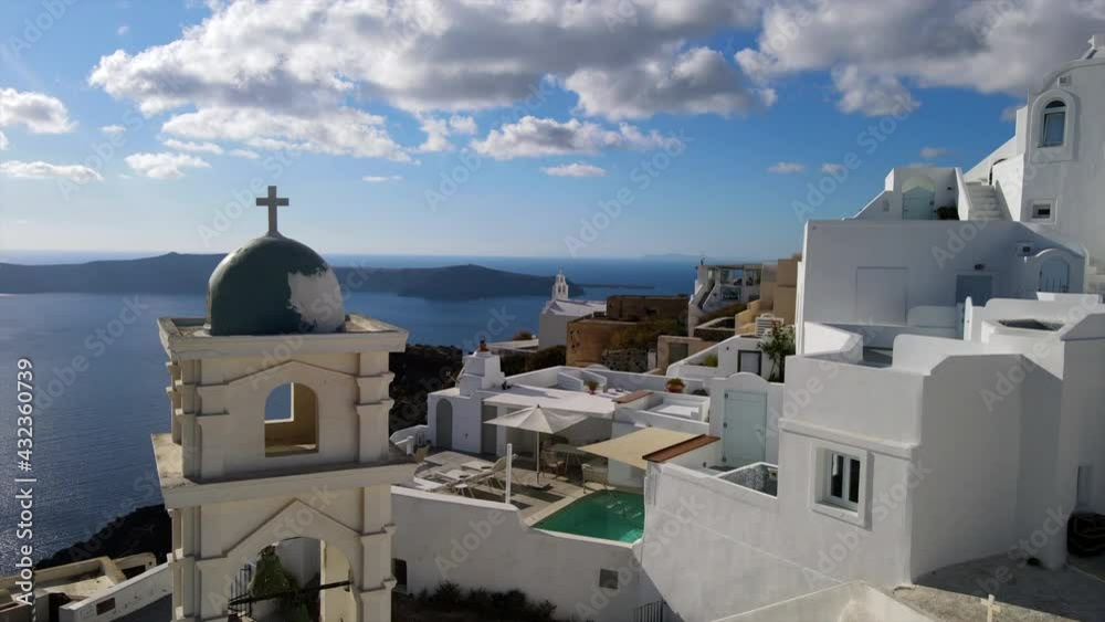 Aerial Shot Of Famous Anastasi Orthodox Church Against Sky, Drone Flying Forward Over Whitewashed City On Sunny Day - Santorini, Greece