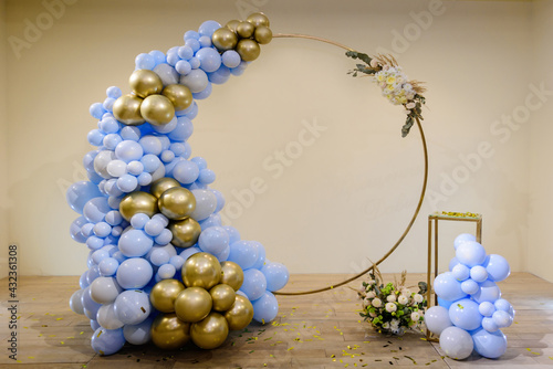 Photo zone with arch, balloons, flowers and cake on birthday party