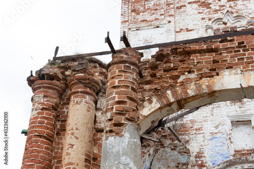 Abandoned old  brick church entrance on ancient wall with column decoration in Dunilovo village photo