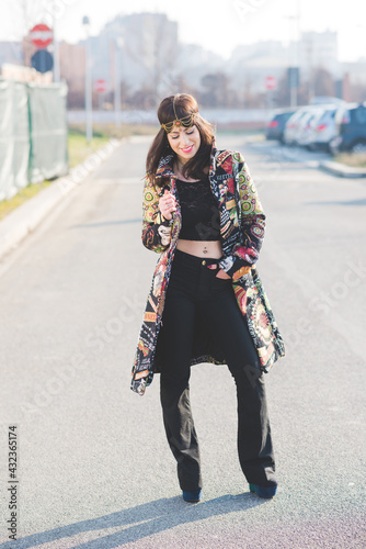 Young beautiful woman posing outdoor city street smiling