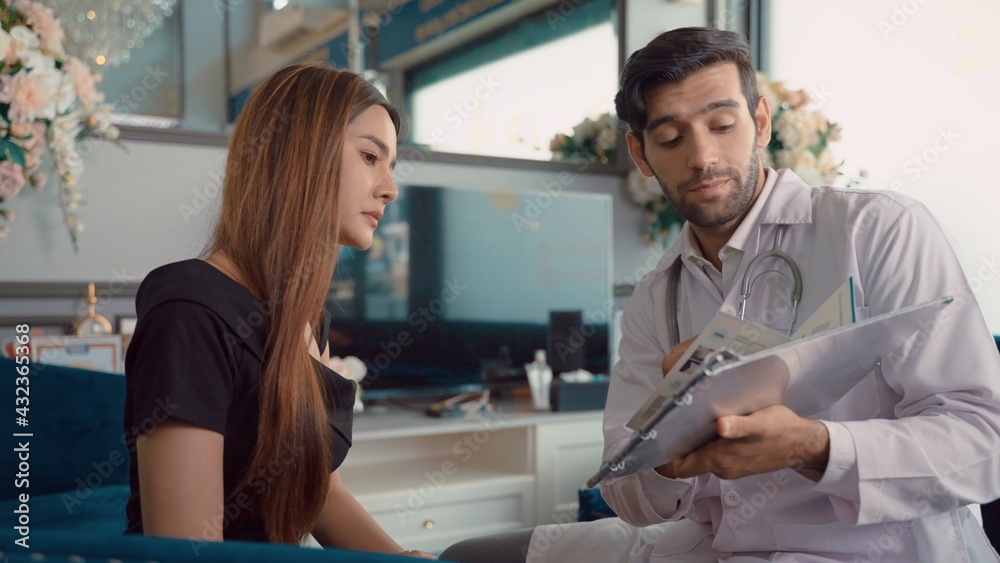 Fototapeta premium Expert male cosmetologist giving consultation to young woman patient sitting on couch in beautician office of medical clinic. Health Care Professional Consultation in the beauty clinic Office.