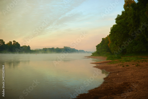 Fog over the river in the early morning far from the city. Ecological purity of nature.