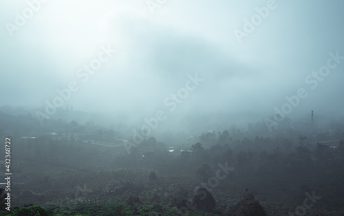 Sun rays and misty at the valley on Bao Loc town. The far side is Tan Hoa Church in Lam Dong province, Vietnam. photo