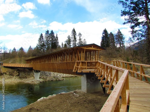 Covered wooden foot bridge over Bohinjska Bistrica river near Bohinj in Gorenjska, Slovenia