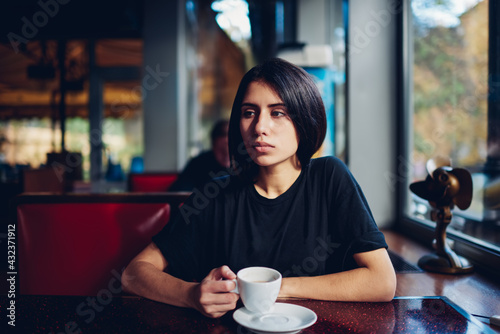 Sad woman with cup of coffee