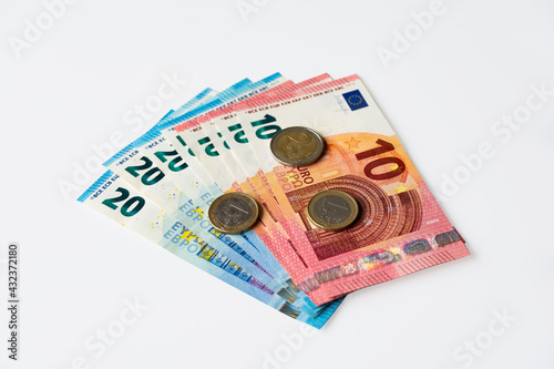 10 and 20 euro banknotes and euro coins isolated on white background.