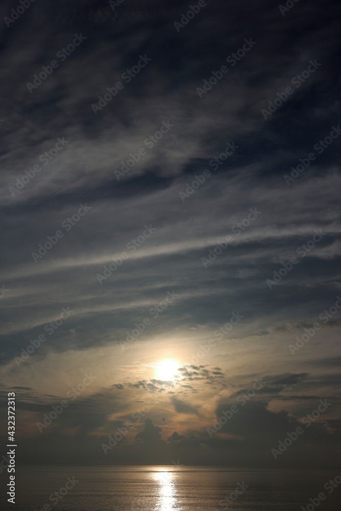 Morning sunrise from the sea in gray clouds Morning sunrise from the sea in gray clouds