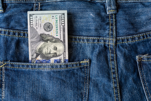 Poverty and unemployment. Concept of financial problems, last money. 100 dollar banknote in jeans pocket.