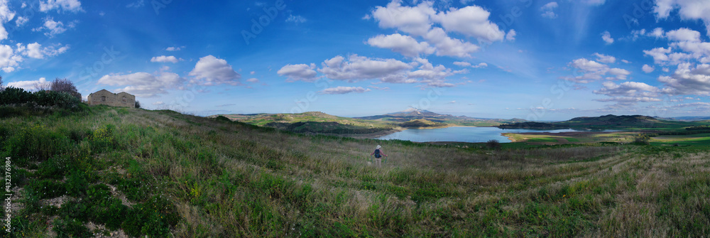Fototapeta premium 360 degree aerial photo of Ogliastro lake in the heart of Sicily with Etna view. Place of great naturalistic value surrounded by hills planted with cereals. A destination for migratory bird species.