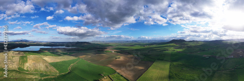 180 degree aerial photo of Ogliastro lake in the heart of Sicily with Etna view. Place of great naturalistic value surrounded by hills planted with cereals. A destination for migratory bird species. photo