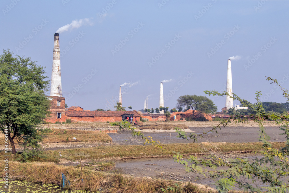 Brick making is going on at the brick kiln.There are many brick kilns in this area of North 24 Parganas.Simultaneously all the ebb and flow of smoke from the chimney Brick making is going on at the brick kiln.There are many brick kilns in this area of North 24 Parganas.Simultaneously all the ebb and flow of smoke from the chimney