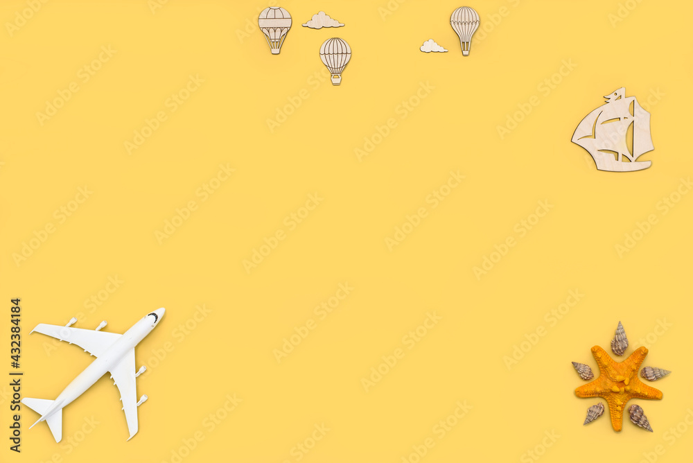 Plane, sailboat, air balloons seashells and starfish on a yellow background top view. Travel background for travel agency, poster. Flat lay view. Plane, sailboat, air balloons seashells and starfish on a yellow background top view. Travel background for travel agency, poster. Flat lay view.