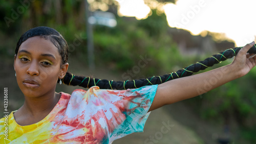 Young black girl in tie dye with long braid
