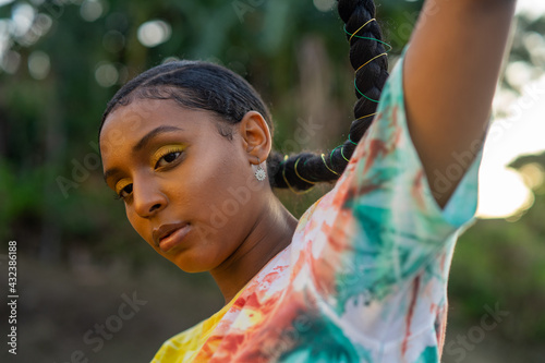 Young black girl in tie dye with long braid