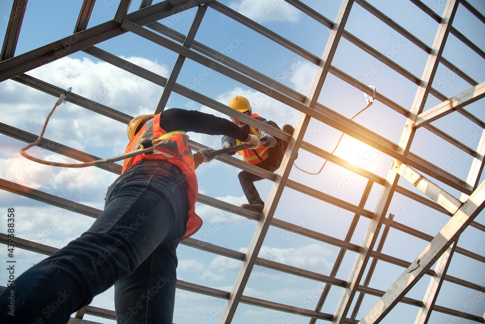 Construction workers install new roofs, roofing tools and fall protection devices. Apply to new roofRoof repair, a Specialist in Roof Forming, is the Replacement of roof plates