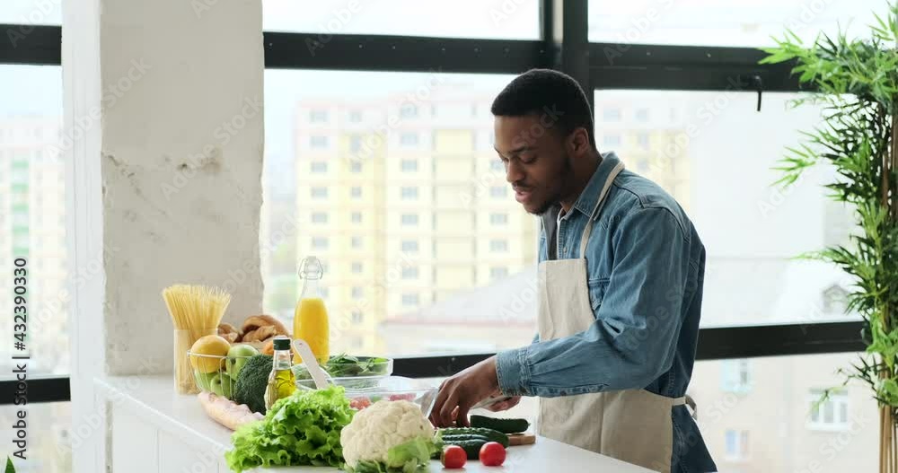 Happy man having fun while preparing food in kitchen at home Happy man having fun while preparing food in kitchen at home