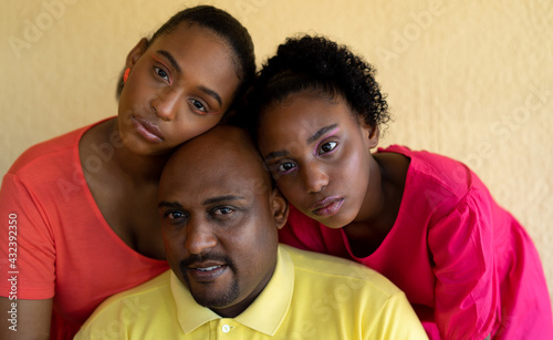 Portrait of Father and Daughters at Home on the Patio