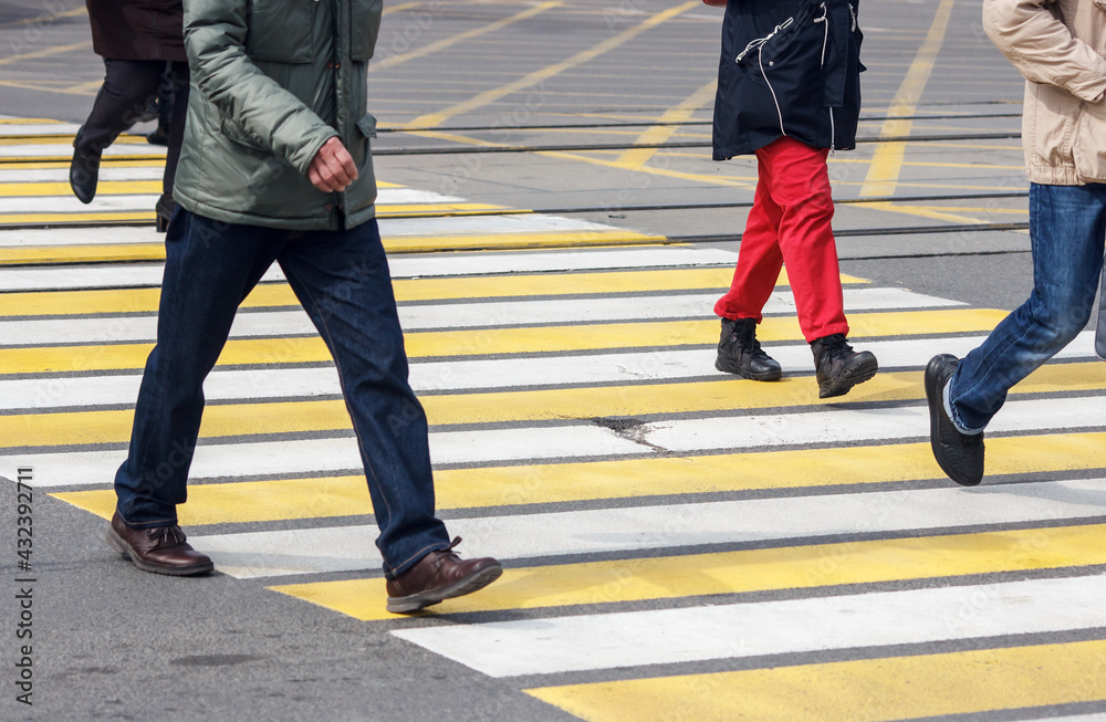 pedestrians cross the street at a pedestrian crossing pedestrians cross the street at a pedestrian crossing