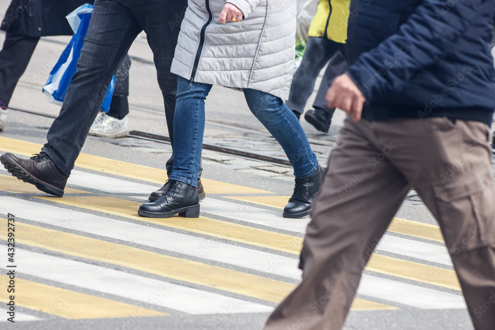 pedestrians cross the street at a pedestrian crossing pedestrians cross the street at a pedestrian crossing