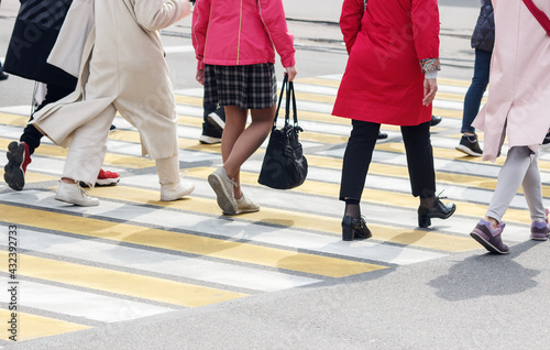 pedestrians cross the street at a pedestrian crossing
