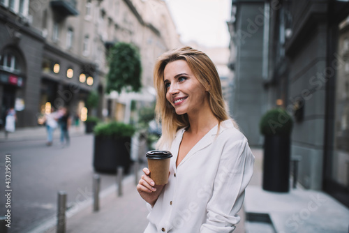 Content woman drinking coffee on street © BullRun