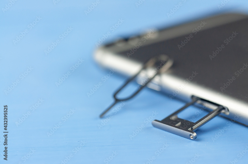 smartphone with a SIM card key, SIM card, SIM card space is open in smartphone with a SIM card key, SIM card, SIM card space is open in