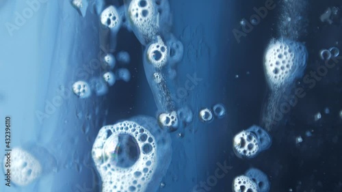 macro photography of soap bubbles the window cleaning chemistry flows down the glass beautifully reflecting