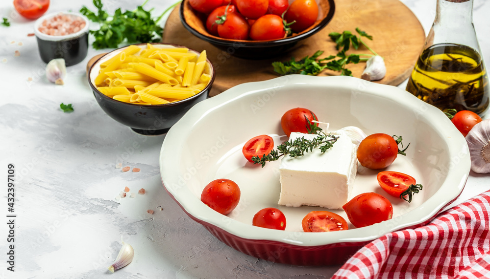 Step-by-step recipe Feta pasta with cherry tomatoes, feta cheese, garlic and thyme. Preparation of ingredients for trending fetapasta