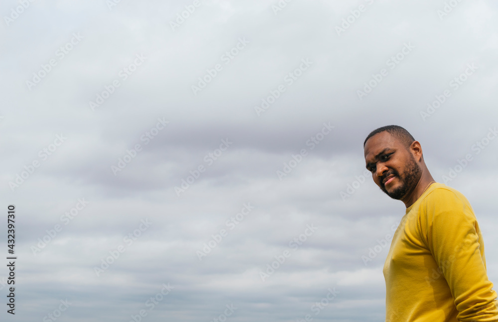 Black man looking at the horizon in a park Black man looking at the horizon in a park