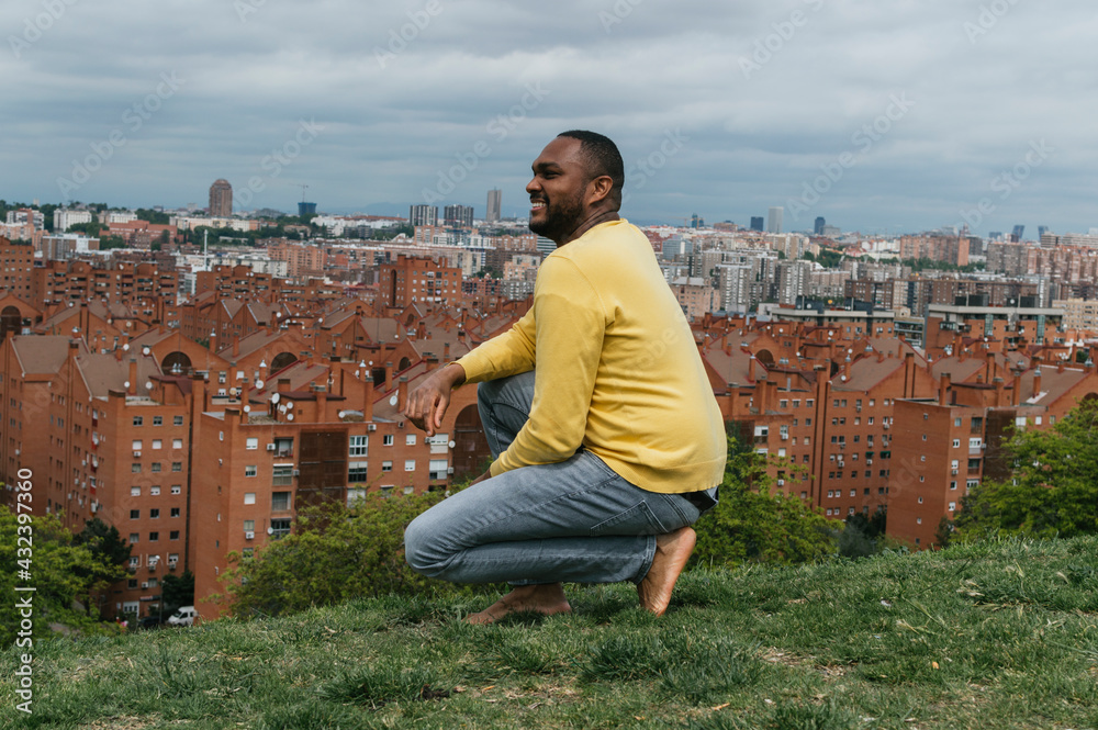 Black man looking at the horizon in a park Black man looking at the horizon in a park