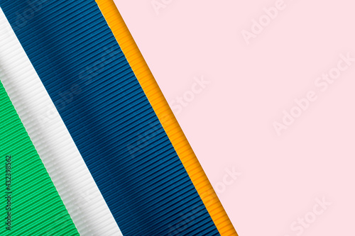 Colored corrugated paper texture. Geometric shapes and lines. Minimalist background. Flat lay. Copy space.
