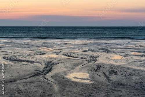 Absolutely beautiful landscape images of Holywell Bay beach in Cornwall UK during golden hojur sunset in Spring