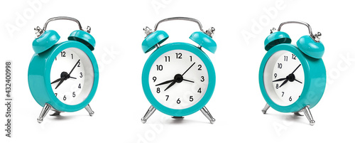 Three teal blue alarm clock over white