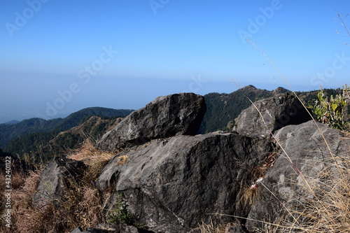 Big rocks on mountain. blue sky in background. Selective Focus On Subject, Background Blur