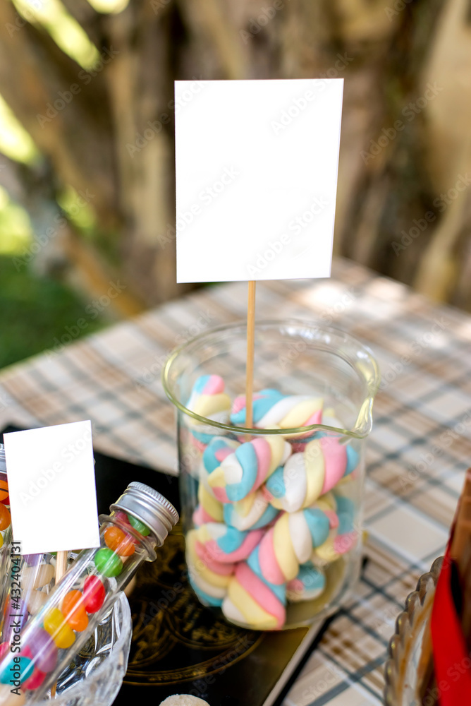 Fototapeta premium Jar with colorful marshmallows on decorated birthday table.