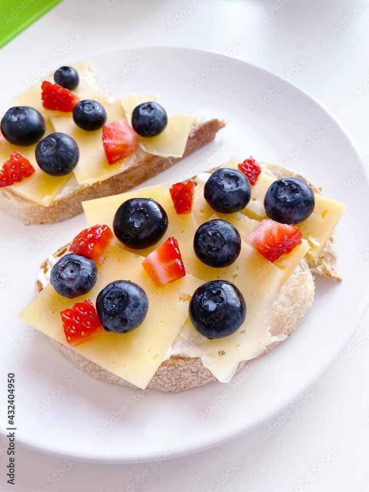 delicious toast for breakfast with buttercream, cheese and strawberries and blueberries. food photos delicious toast for breakfast with buttercream, cheese and strawberries and blueberries. food photos