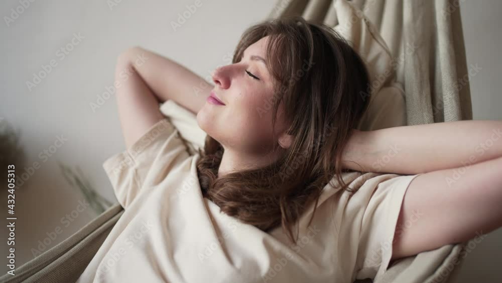 Relaxing in a hammock. A beautiful woman rests quietly and enjoying. break. Positive thinking Relaxing in a hammock. A beautiful woman rests quietly and enjoying. break. Positive thinking