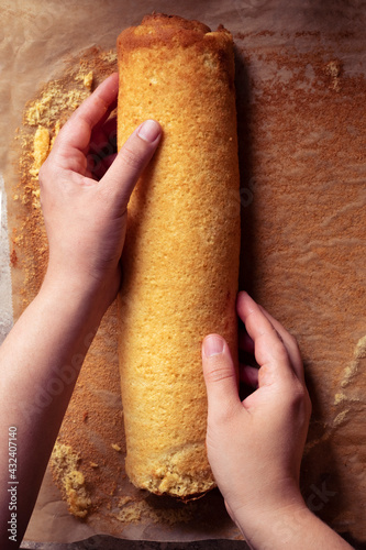 hands holding a swiss roll ready