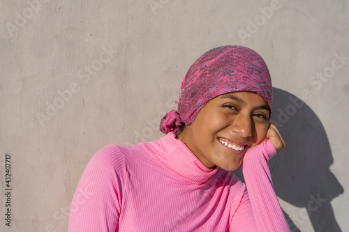 Young woman with cancer showing hope in her smile. Hope, Struggle, Empowerment Concept.