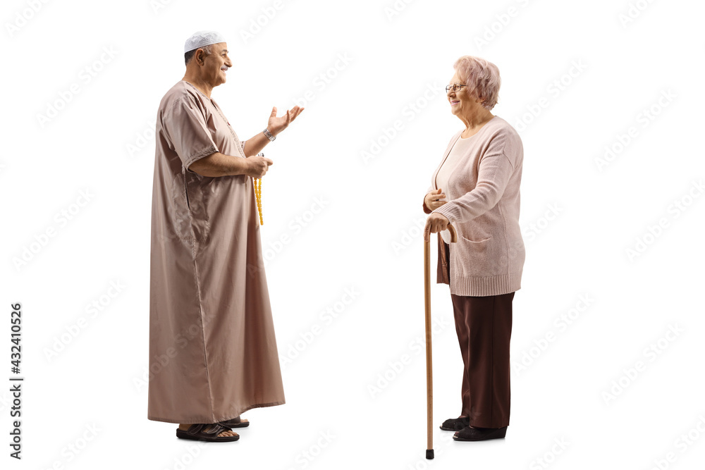 Full length profile shot of a mature muslim man talking to an elderly woman with a walking cane