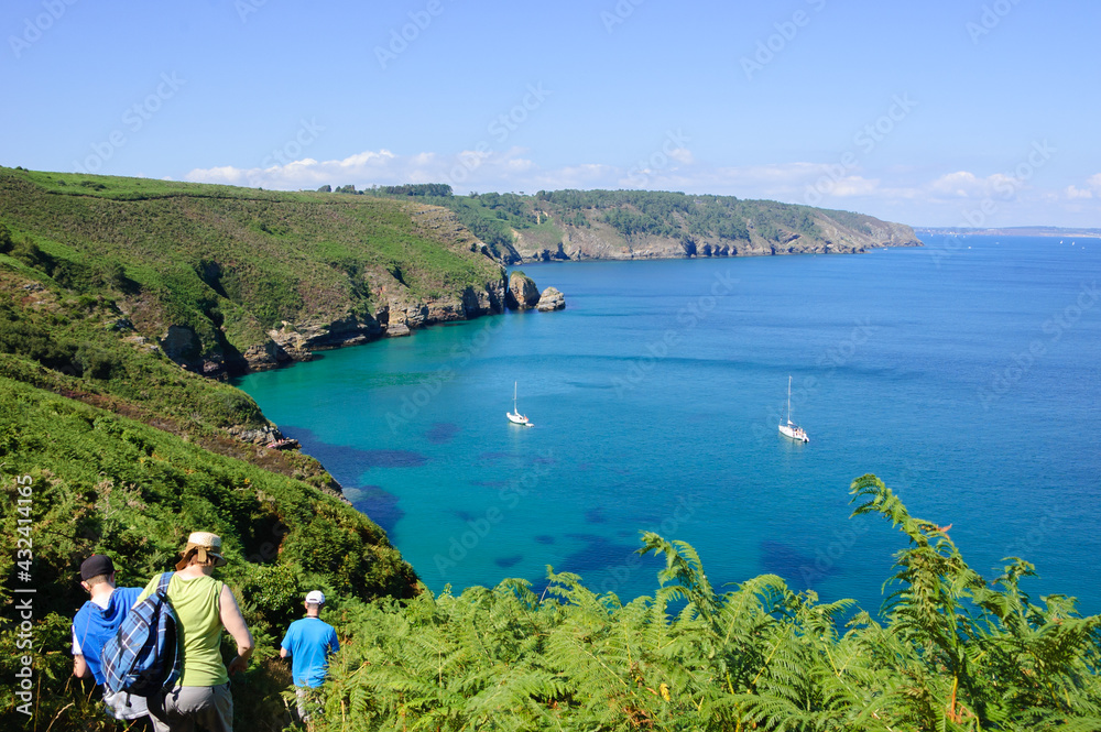 Φωτογραφία Tourists hiking (unrecognizable; back view)  at the hills near Cap de la Chevre with a beautiful view on a bay with white sailboats